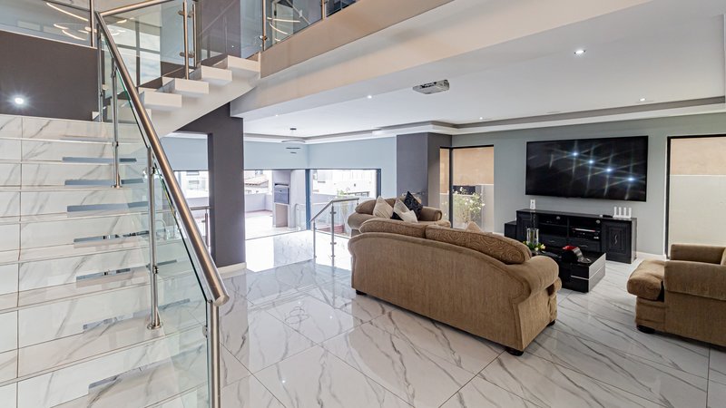 Unedited photo 1 of the same open-plan living and kitchen area, before staging