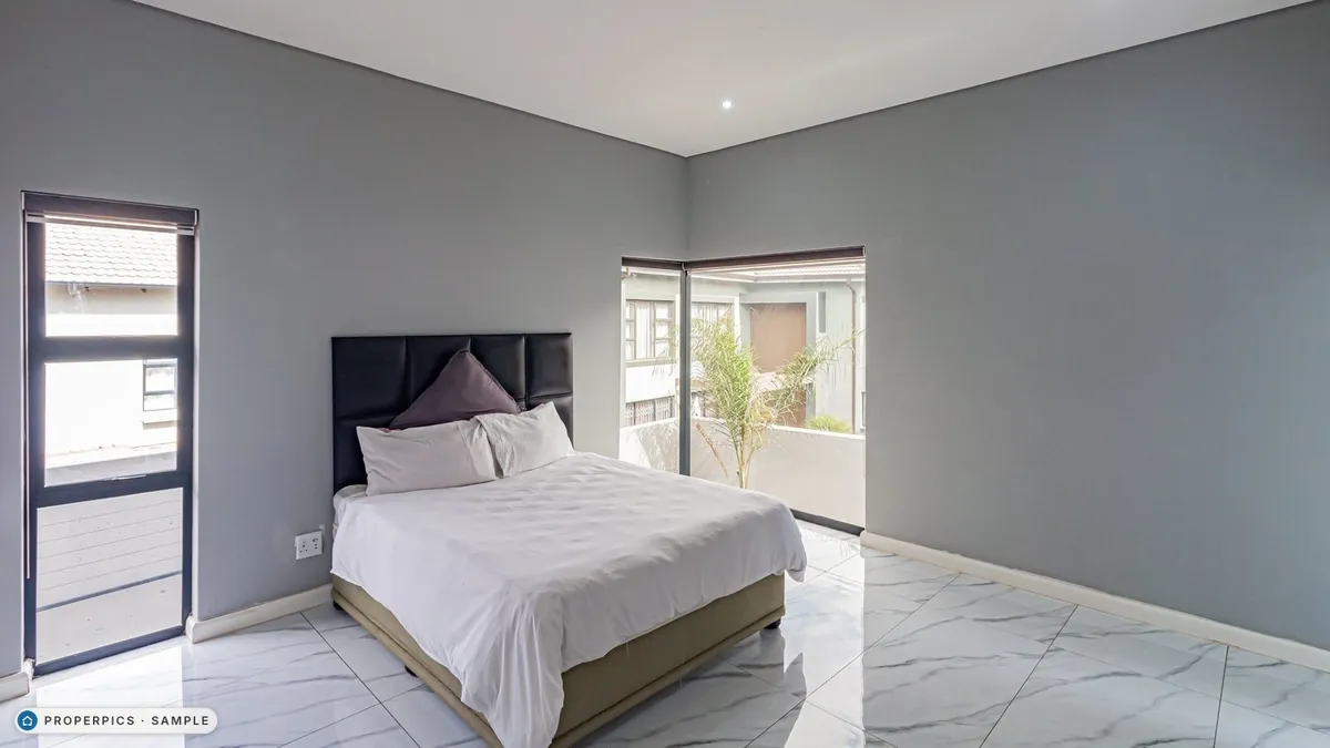 A bedroom as photographed from the corner opposite the bed, with its own furniture