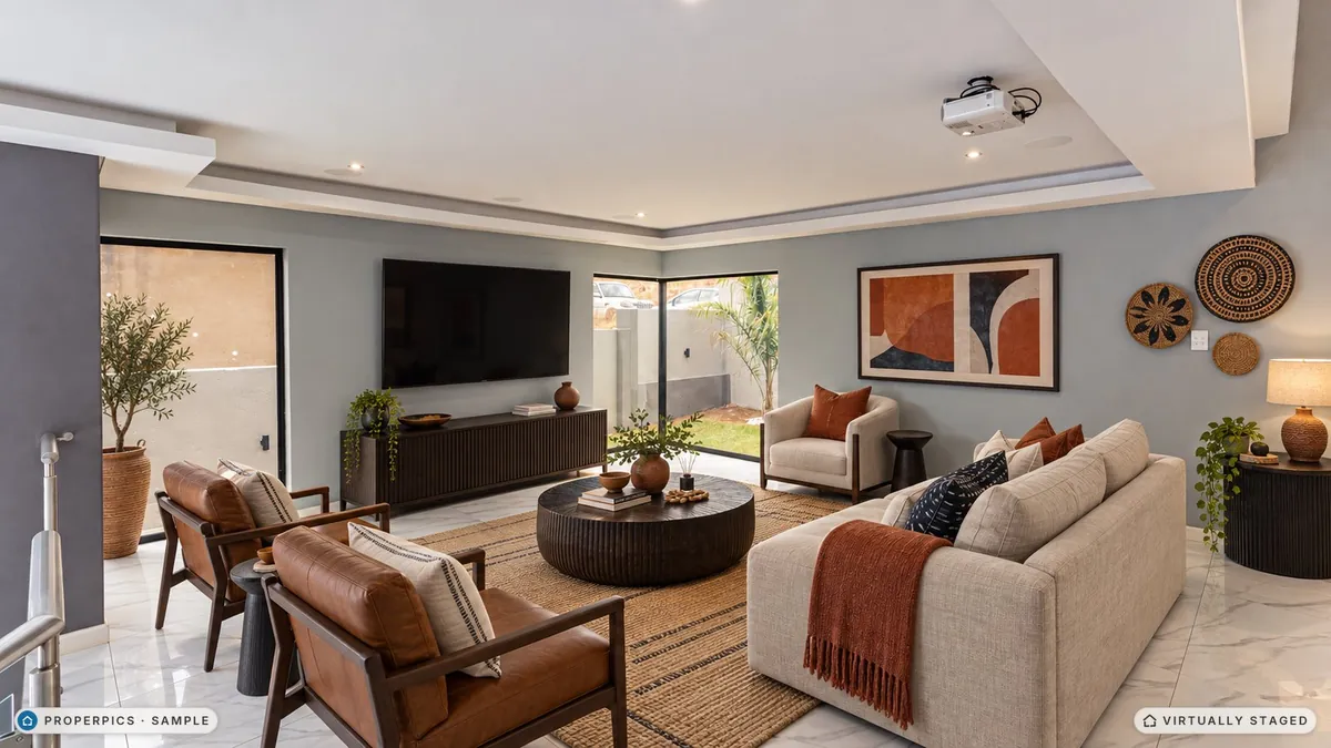 The same living room virtually staged in the Afro-contemporary style by ProperPics, marked as virtually staged