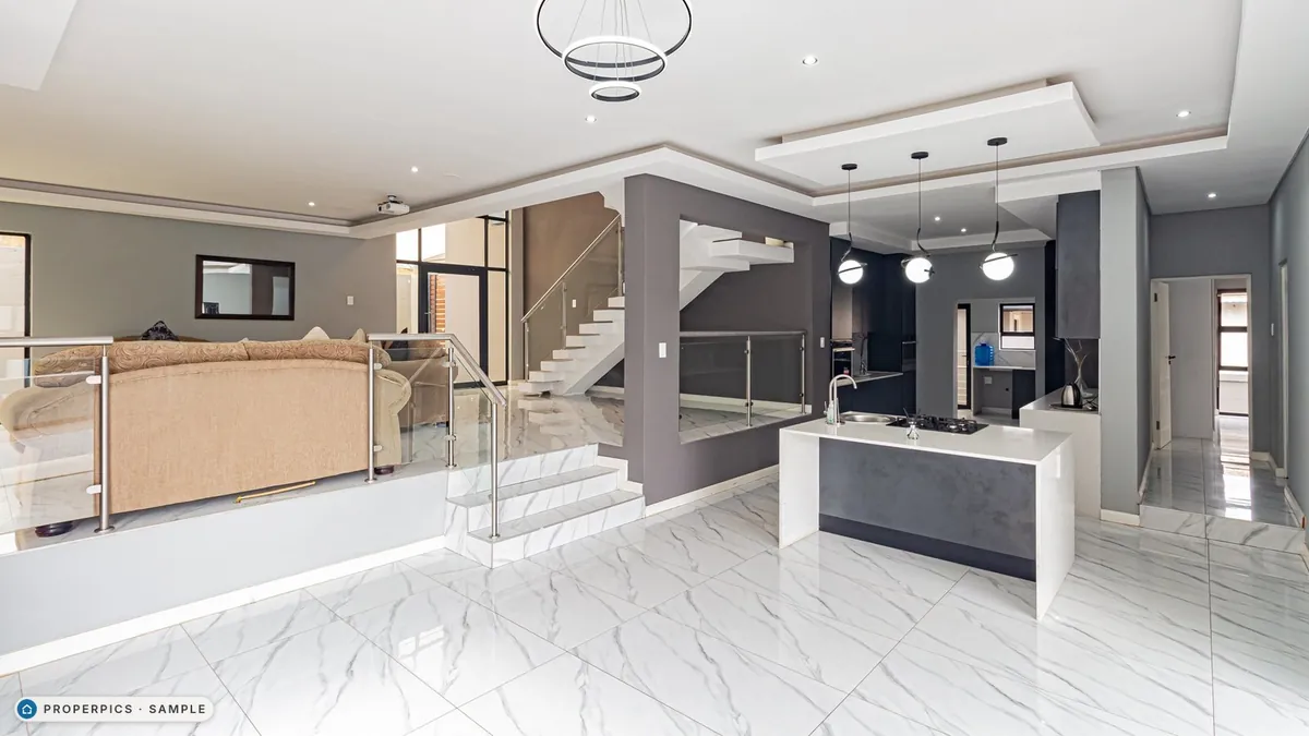 The open-plan living and dining area as photographed, with its existing furniture