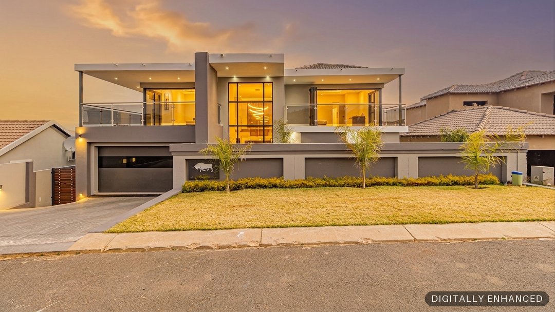 The same front elevation returned as a dusk shot by ProperPics, with an evening sky and the interior lights on
