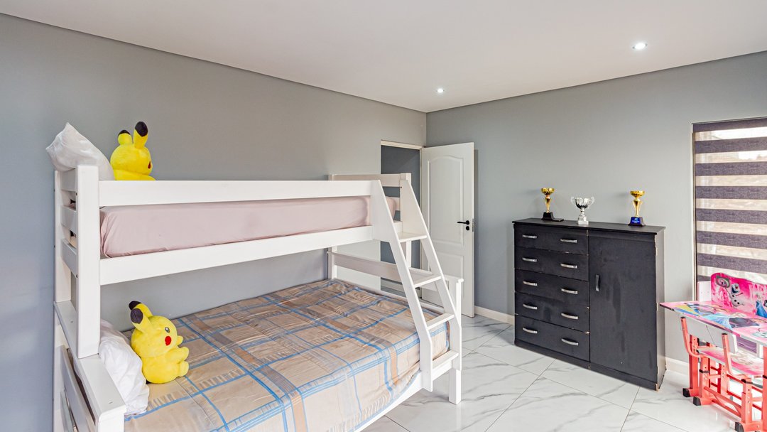 A children's room with a bunk bed and toys, before restyling