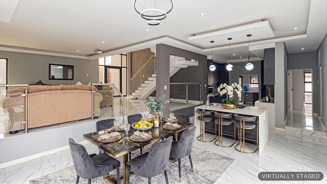 The same open-plan dining area virtually staged with a dining table and dressed island by ProperPics