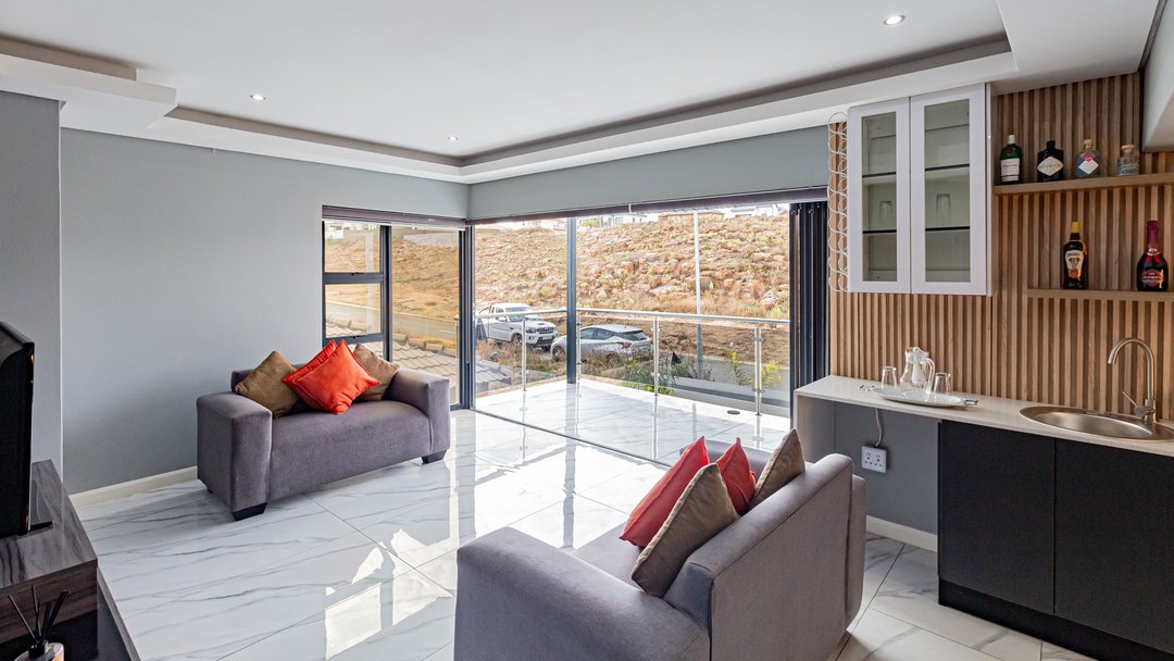 An upstairs lounge with two worn couches, before restyling