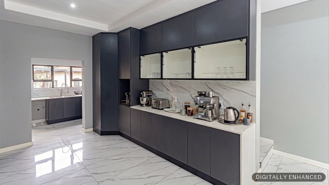 The same scullery, brightened and dressed with small appliances by ProperPics, marked as digitally enhanced