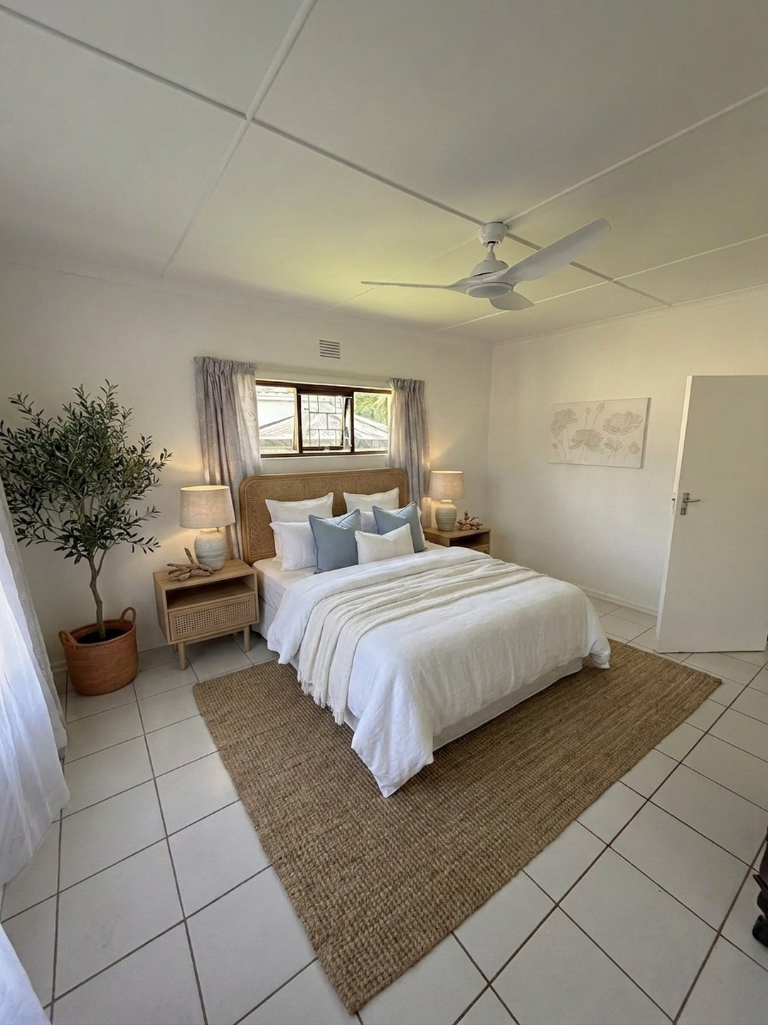 The same bedroom cleared and virtually staged in a coastal look by ProperPics